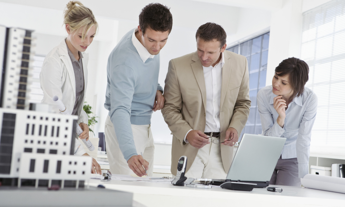 Group of business people discussing about a document.